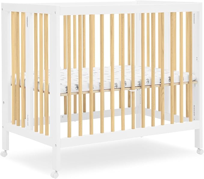 Delta Children Mia Portable Folding Mini Crib with 1.5-Inch Mattress - Greenguard Gold Certified, Bianca White/Natural - LeafyLoom