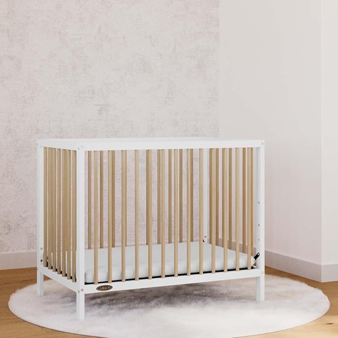 Graco Teddi 4-in-1 Convertible Mini Crib with Bonus Water-Resistant Mattress (White with Driftwood) – GREENGUARD Gold Certified, 2.75-Inch Mattress Included, Convenient Size, Easy 30-Minute Assembly - LeafyLoom