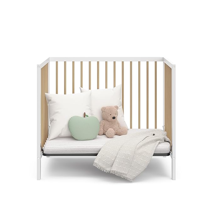 Graco Teddi 4-in-1 Convertible Mini Crib with Bonus Water-Resistant Mattress (White with Driftwood) – GREENGUARD Gold Certified, 2.75-Inch Mattress Included, Convenient Size, Easy 30-Minute Assembly - LeafyLoom