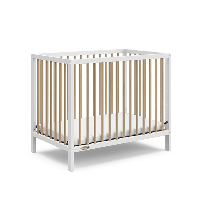 Graco Teddi 4-in-1 Convertible Mini Crib with Bonus Water-Resistant Mattress (White with Driftwood) – GREENGUARD Gold Certified, 2.75-Inch Mattress Included, Convenient Size, Easy 30-Minute Assembly - LeafyLoom